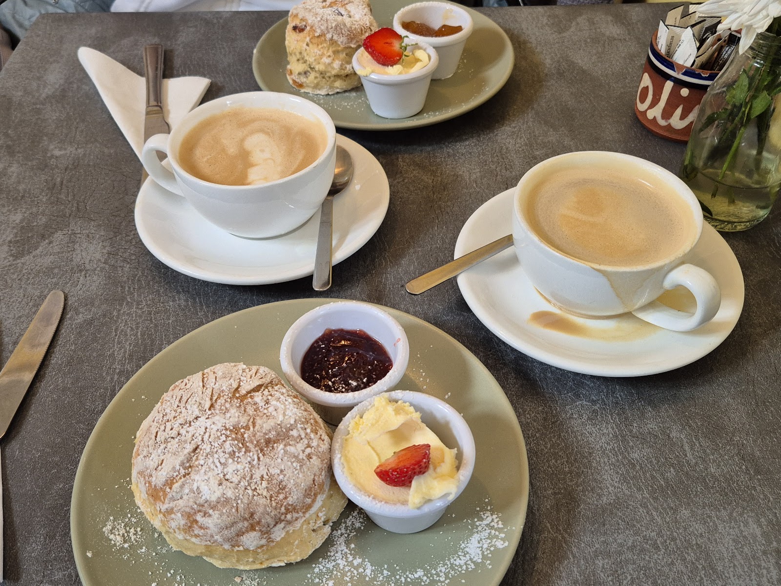 Cream tea at Olives Cafe — a fresh scone with jam, clotted cream and two coffees