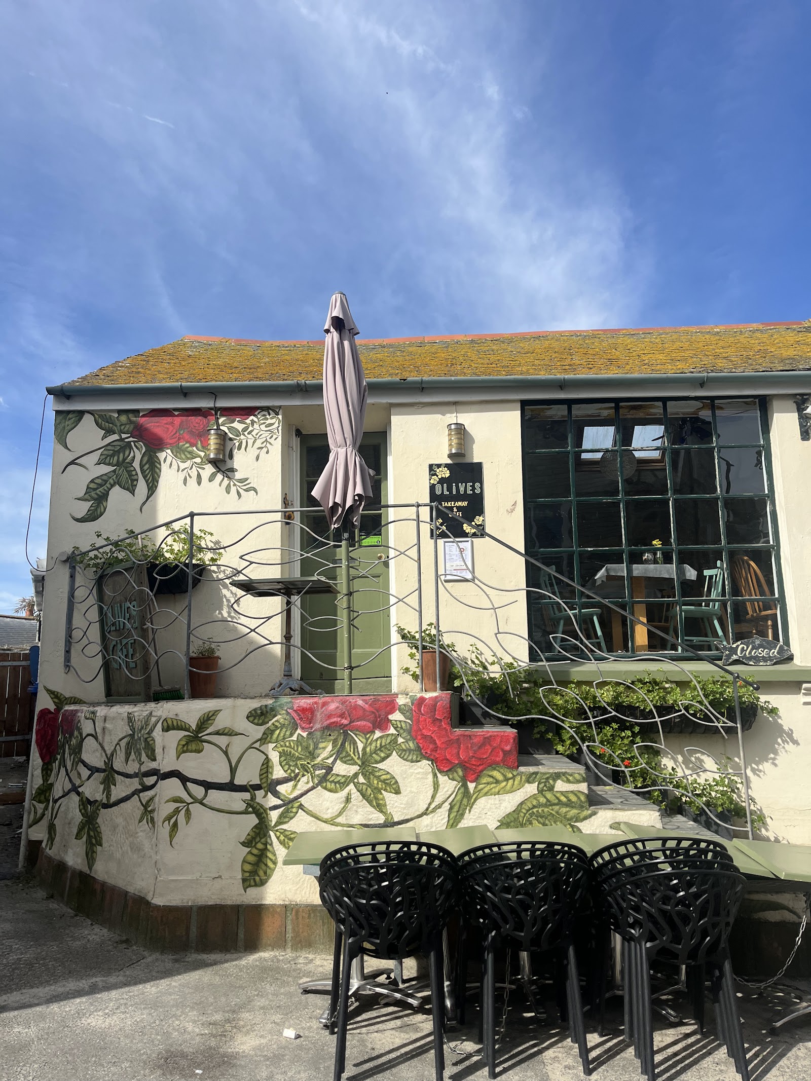 The cafe's courtyard terrace with tables in the sun