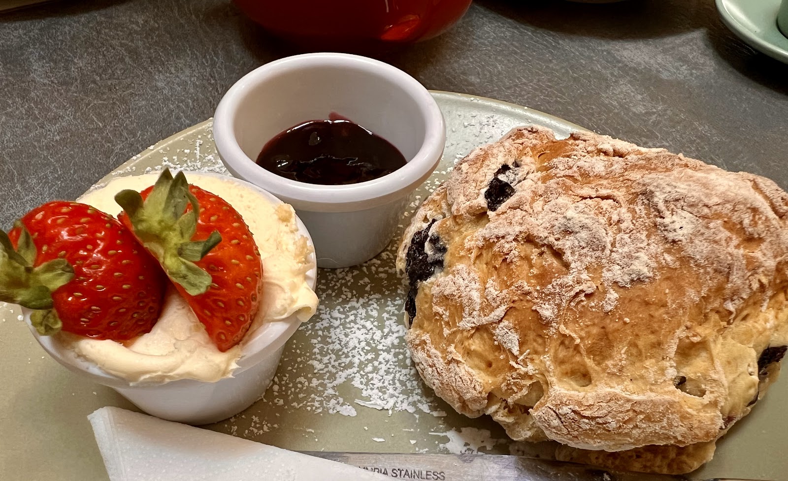 Blueberry scone with strawberries, clotted cream and jam